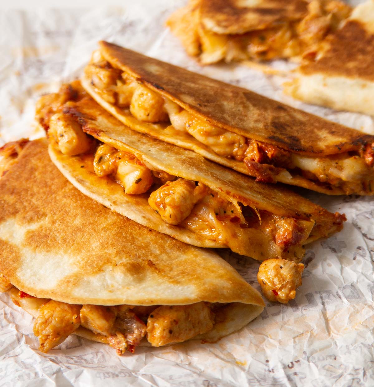 3 marry me chicken tacos stacked on each other showing filling