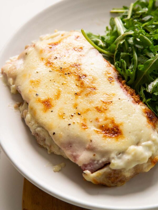 chicken croque monsieur on small white plate with salad