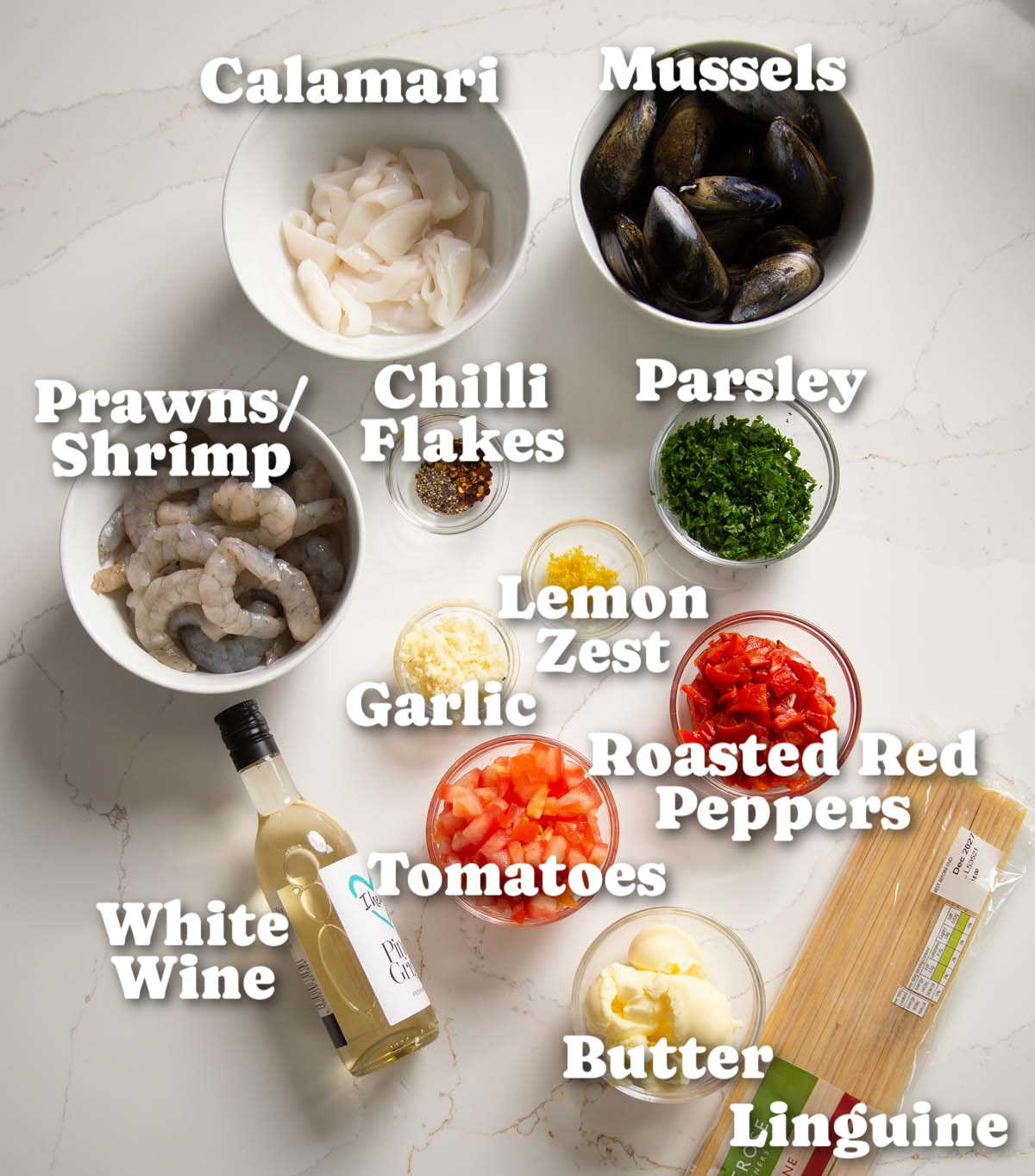 overhead shot of seafood pasta ingredients with text labels
