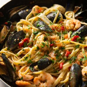 close up shot of seafood pasta in large pan
