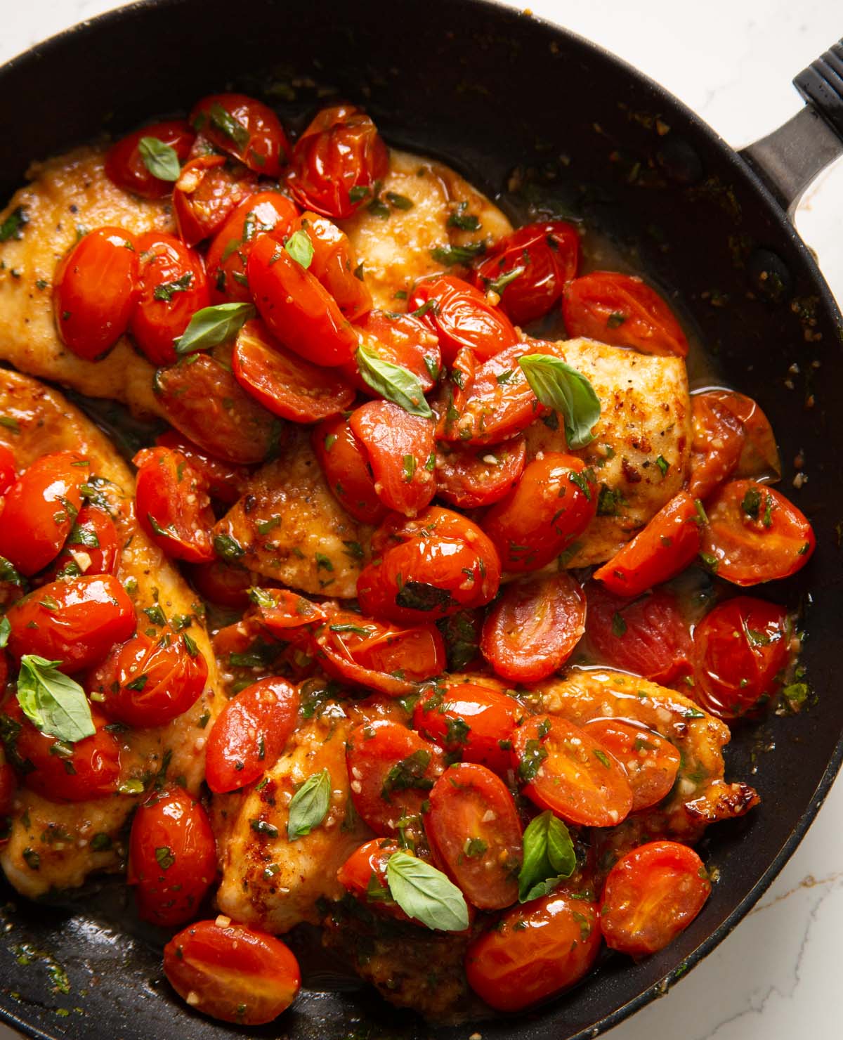 overhead shot of tomato basil chicken in large pan