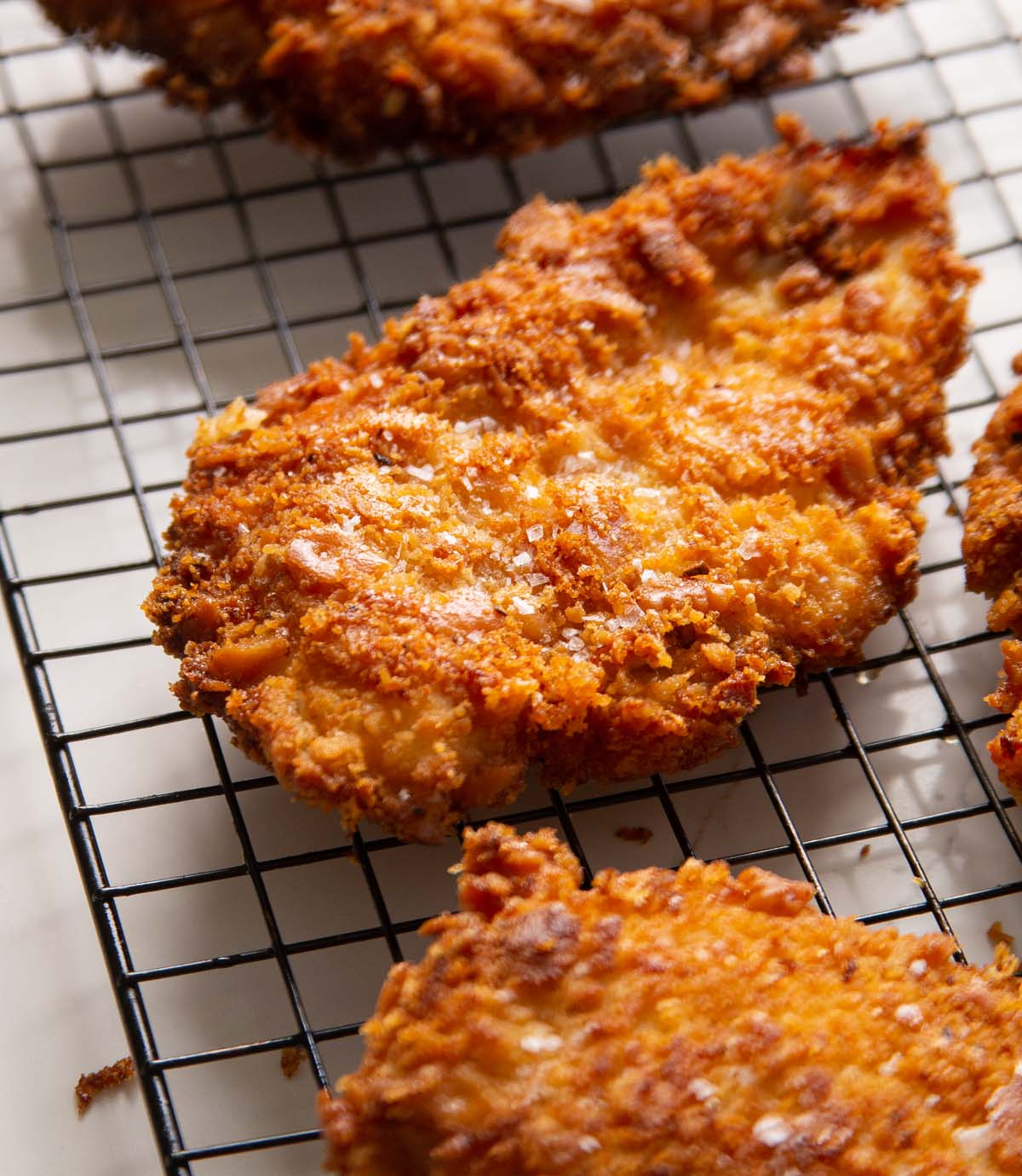 close up shot of ritz cracker chicken on wire rack
