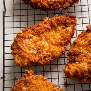 close up shot of ritz cracker chicken on wire rack